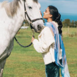 woman with scarf and white horse