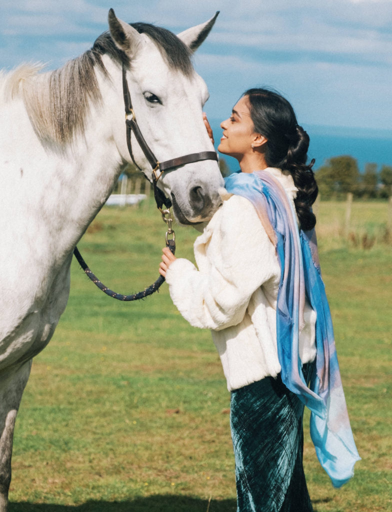 woman with scarf and white horse