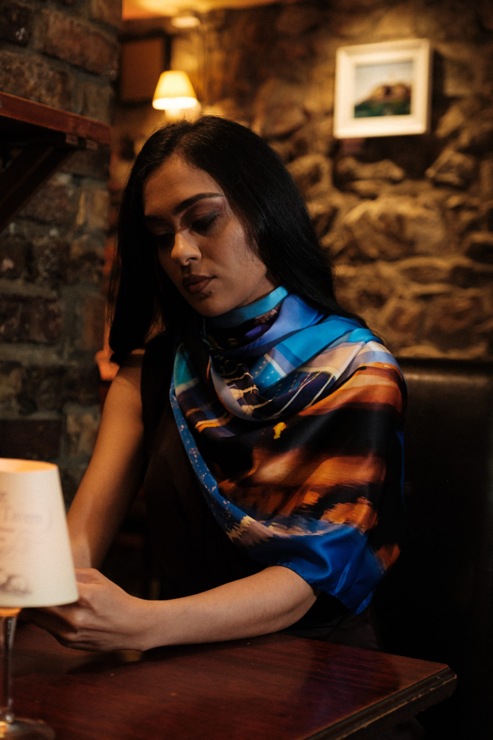 Woman sitting at a table looking pensive