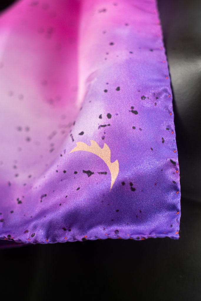 Close up of Siobhan McKenna silk scarf. Purple and pink hues